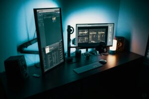 Modern dual monitor computer setup with blue lighting