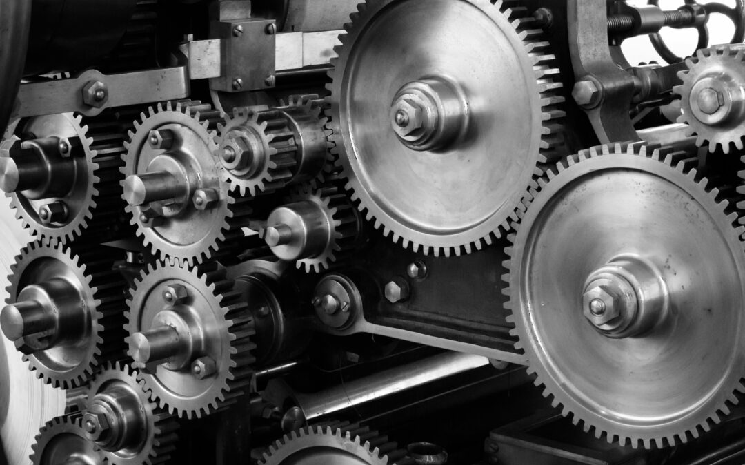 Close-up of industrial metal gears in machinery.